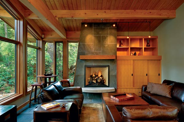 Bluestone is used as the fireplace material in this contemporary Canadian timber frame. A simple Douglas fir mantel mimics the structural beams. Photo by Vince Klassen.