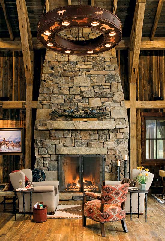 The stunning stacked-stone fireplace creates an instant focal point in this 850-square-foot Montana timber frame. Photo by Heidi Long.